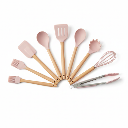 Pink silicone kitchen utensils set flat lay